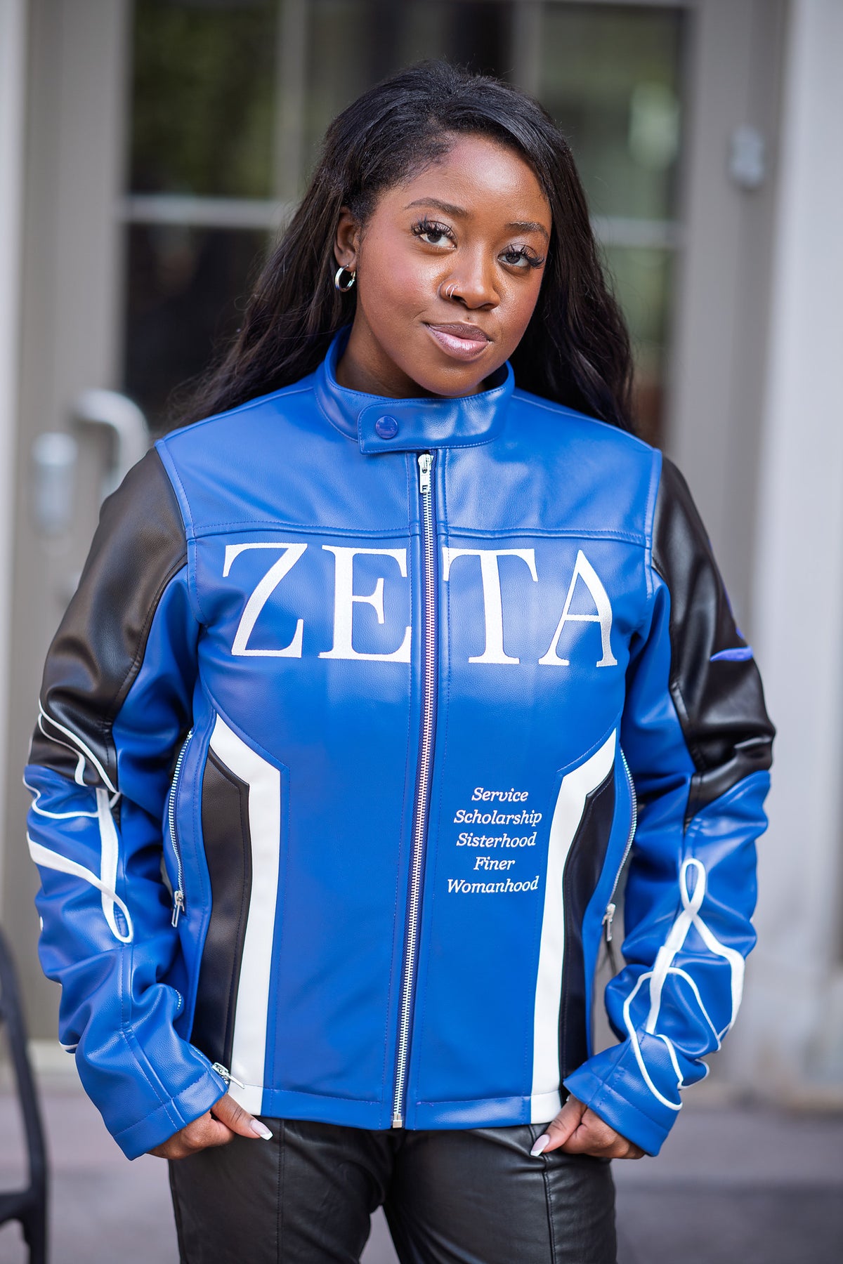 Zeta Phi Beta leather jacket front view worn outdoors on campus
