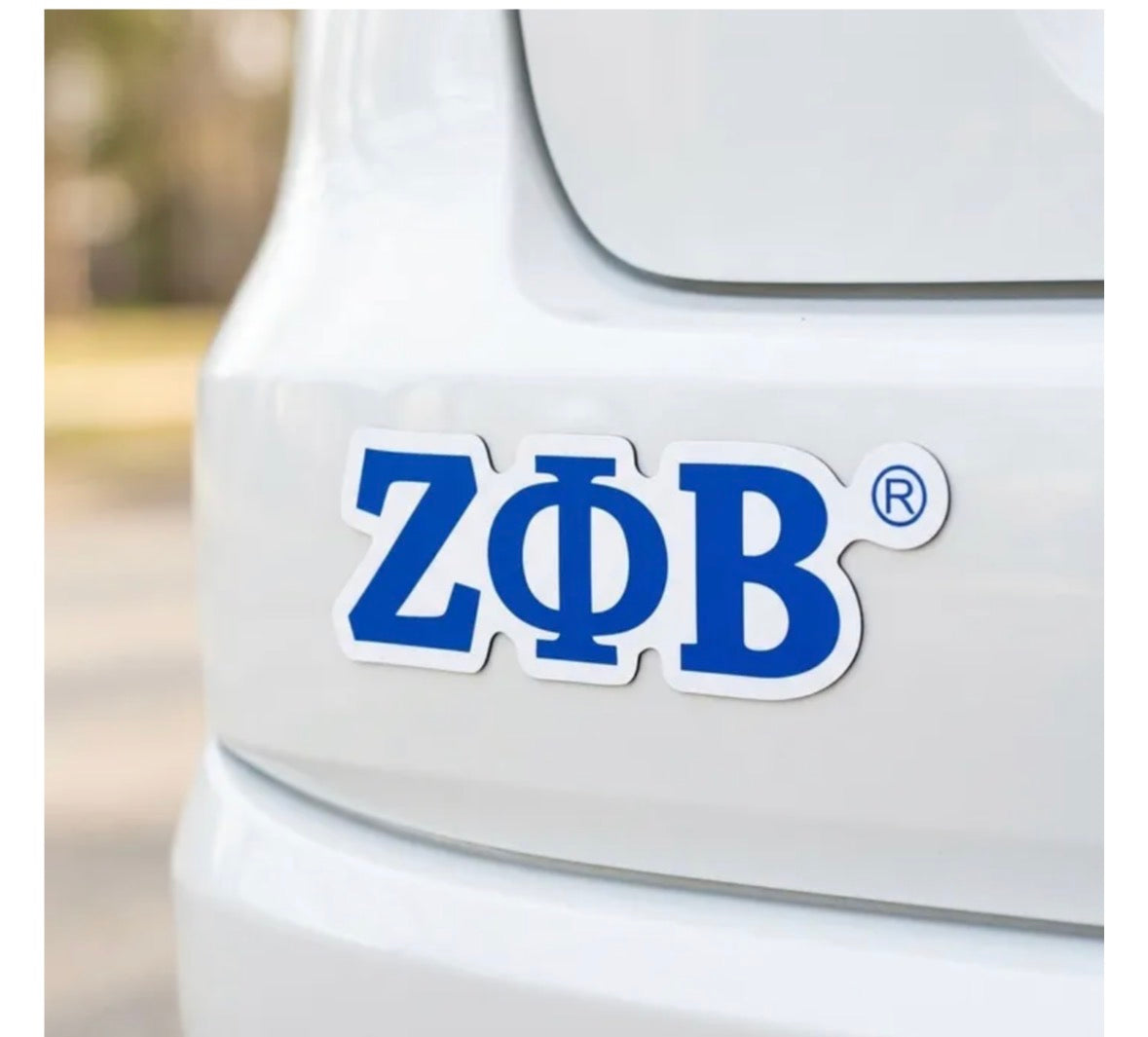 Royal blue die-cut Zeta Phi Beta ZPB car magnet with a white border on the back of a white car.