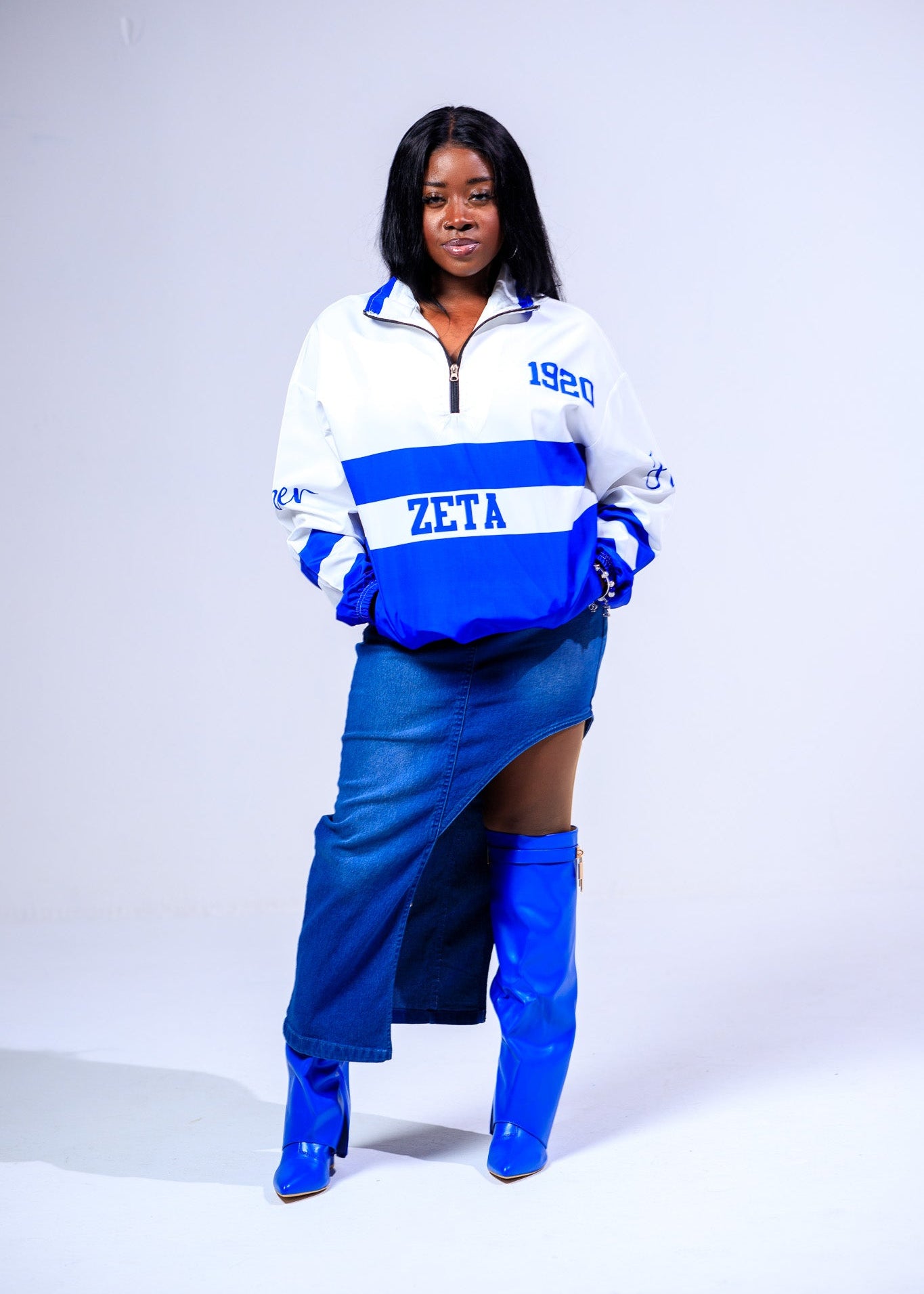 Person wearing a blue and white jacket with 'Zeta' text on a white background