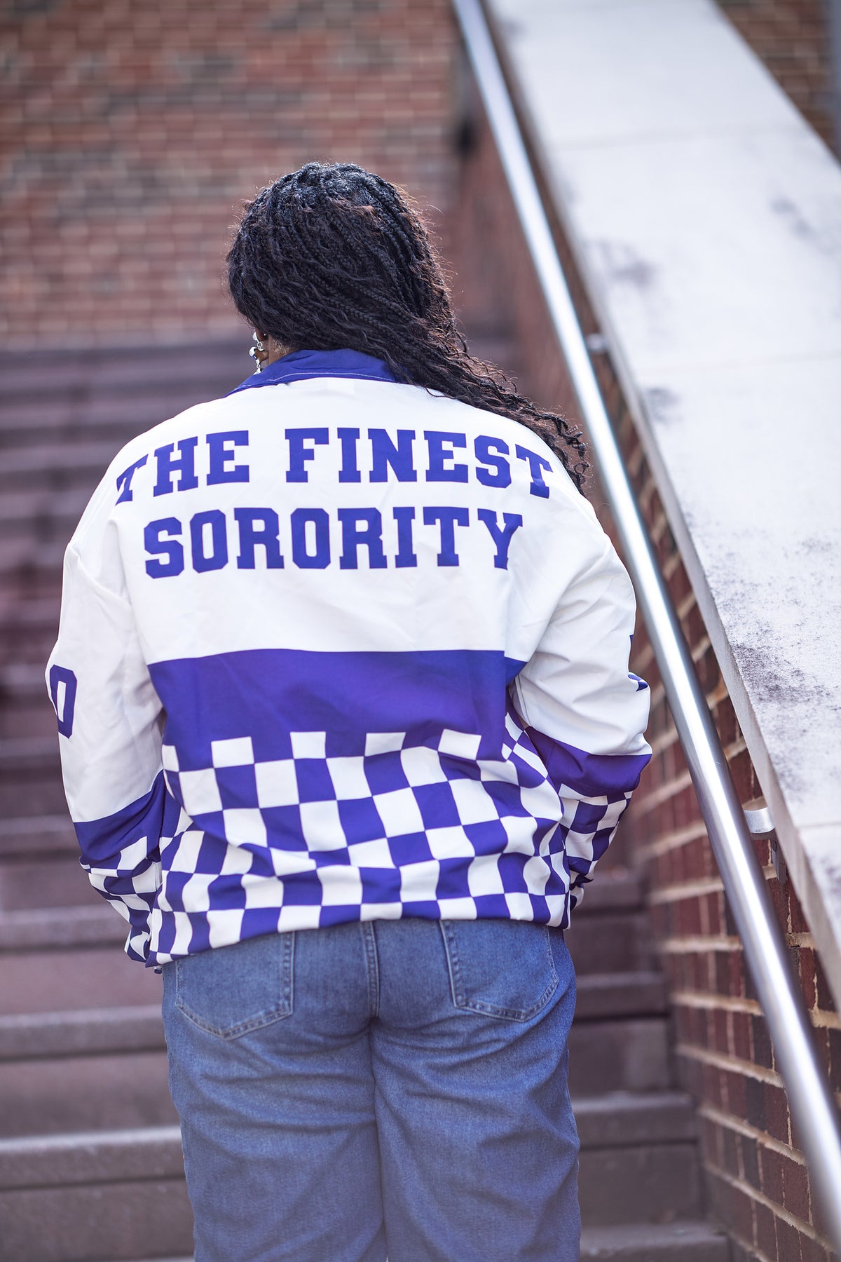 Zeta Phi Beta windbreaker back view on campus, THE FINEST SORORITY print