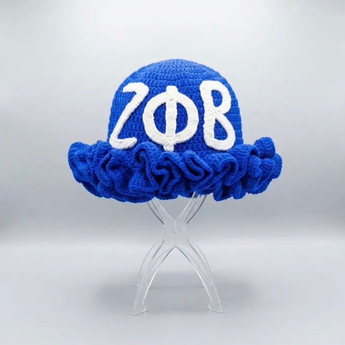 Zeta Phi Beta crochet hat with a ruffled brim on a clear display stand, front view